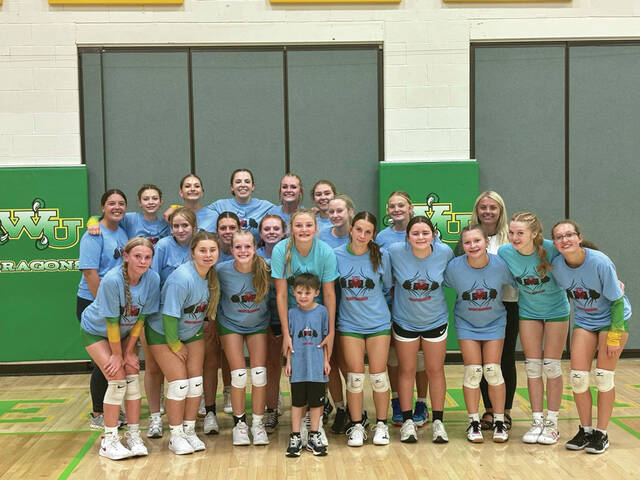 130893638_web1_WUHSVolleyball
The players and coaches from the West Union High School volleyball programs pose with young Avery Mashburn after Friday nights match with the Peebles Lady Indians. (Photo provided)
