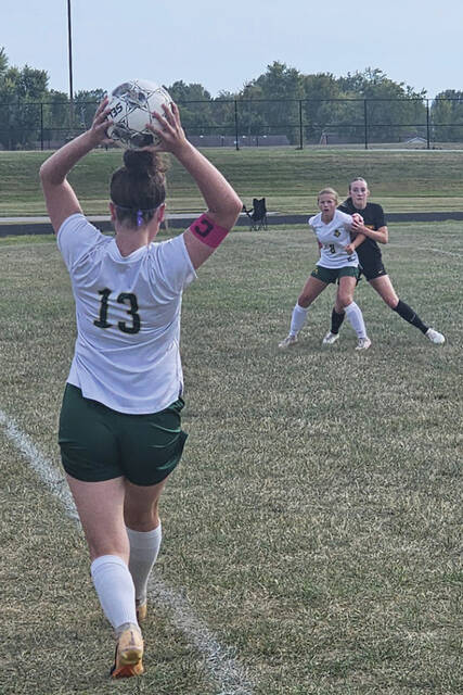 130908242_web1_NAGirlsSoccer
As teammate Jerzi Tong (8) blocks out her Georgetown defender, North Adams Tatum Grooms (13) attempts a sideline throw-in during the Lady Devils 3-0 loss. (Photo by Mark Carpenter)