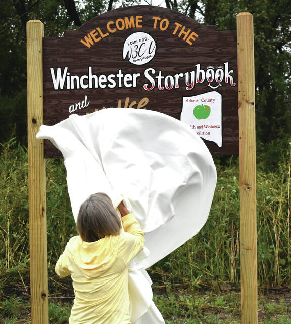 130952403_web1_Joyce-Porter-Walking-Path
Winchester resident and project lead Joyce Porter unveils the sign at the Winchester Storybook and multi-use trail on Monday, September 30. (Photo by Ryan Applegate)