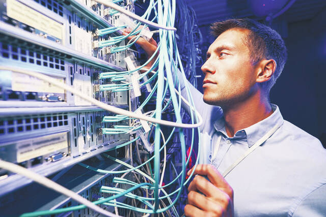 131327307_web1_Fiber-Optic-Tech
A Fiber Optic Technician examines cables at a local business to ensure proper installation meets existing industry standards.