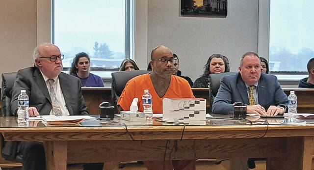 131354101_web1_Johnson-1
David L. Johnson (center) and his defense team of C. Nicholas Ring right) and Bruce S. Wallace(left) direct their attention to the Judge on Friday during the change of plea hearing. (Photo by Ryan Applegate)