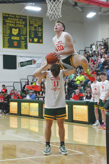 131403919_web1_Schweickart-C103
Using teammate Jayce Rothwell as a prop, North Adams Breestin Schweickart soars towards the rim in the Slam Dunk Contest. (Photo by Mark Carpenter)