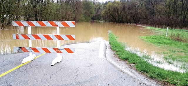 131424333_web1_Flood-1
State Route 348 from mile marker two until the intersection of Compton Hill Rd was flooded and impassable for much of the weekend and forced motorists to find alternate routes. (Photo by Ryan Applegate)