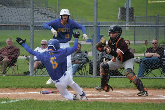 131532457_web1_Doyle-Slide
Manchesters Landen Doyle (5) slides safely into home plate with one of the Greyhounds 12 runs in their May 21 district quarterfinal win over Eastern Pike. (Photo by Mark Carpenter)