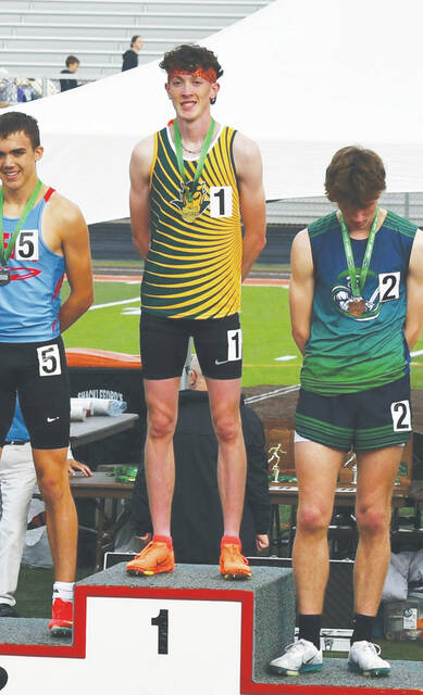 131554074_web1_Beau-Regional
North Adams junior Beau Hesler stands proudly on the podiums top spot after winning a Division III regional championship in the 800M run. (Photo by Danielle Jodrey)