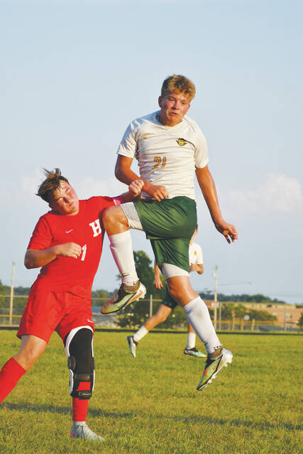 <p>Soccer can be a high-flying sport, seen here as North Adams sophomore Jaxon Baldwin (right) goes airborne to elude a crashing Hillsboro opponent. (Photo by Mark Carpenter)</p>