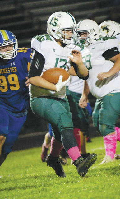 <p>North Adams’ ball carrier Bradley Robinson looks for running room in action from the Green Hornets’ 52-9 loss at Manchester on October 8. (Photo by Sarah Wilson-Dinsmore) </p>