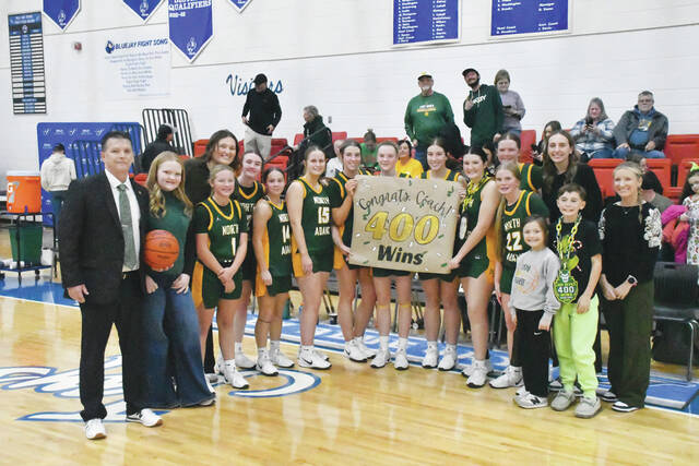 131993972_web1_Davis-400
North Adams Lady Devils head coach Rob Davis, his team, and staff celebrate after Daviss 400th career win, a 65-17 victory at Ripley on December 11. (Photo by Mark Carpenter)