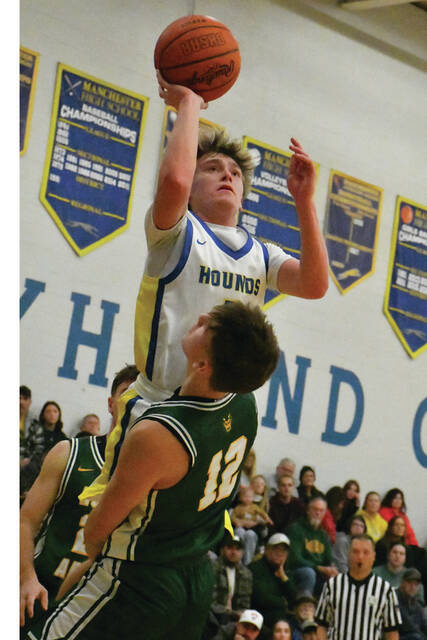 <p>Manchester’s Parker Hayslip was called for the offensive foul on this play but he did lead the Greyhounds with 23 points in their December 16 home loss to North Adams. (Photo by Mark Carpenter)</p>