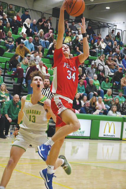 Peebles Josh McClary drives to the rim in action from the Tribes win at West Union on February 13. McClary did most of his damage away from the rim, sinking four three-point buckets on his way to a 19-point night. (Photo by Mark Carpenter)