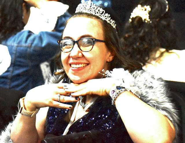Following the crowning ceremony, one of Night to Shines honored guests smiles proudly in her tiara, a reminder that every participant is celebrated as royalty for the evening. (Photo by Ryan Applegate)
