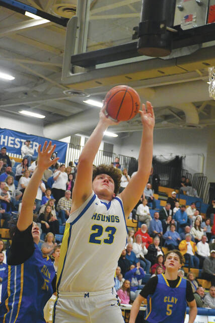 Manchesters Colton McChesney goes up strong to the rim in action from the Greyhounds Division VII district tournament win over Portsmouth Clay on February 26. (Photo by Mark Carpenter)