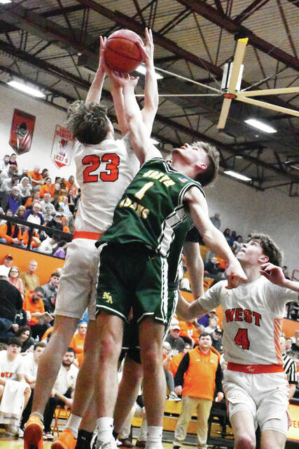 North Adams Kaleb Eldridge (1) battles Portsmouth Wests Logan McIntire (23) for a rebound during the two teams district semifinal contest on March 3. (Photo by Mark Carpenter)