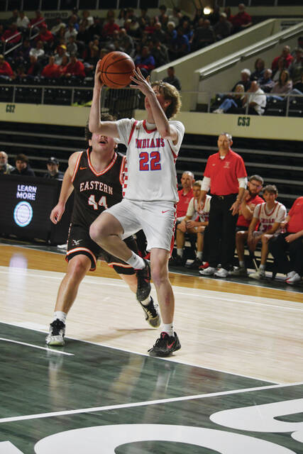 Peebles Connor Gross drives the baseline to the rim in action from the Tribes district championship win on March 8. Gross made his biggest play on the defensive end with a blocked shot int he final minute to help preserve the victory. (Photo by Mark Carpenter)
