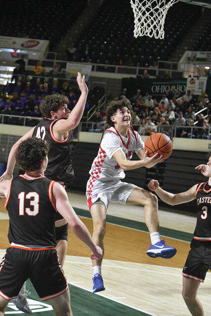 Peebles Josh McClary goes up and under Eastern defender in action from the Indians 56-54 district championship win on March 8 at The Convo. McClary led the Tribe with 19 points. (Photo by Mark Carpenter)