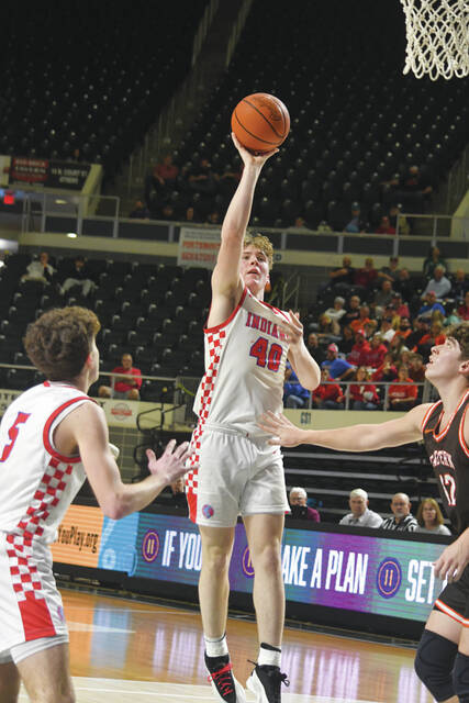 Peebles freshman Keegan Puckett scores on an offensive rebound during the Indians two-point win over Eastern Pike in Sundays district championship game. (Photo by Mark Carpenter)