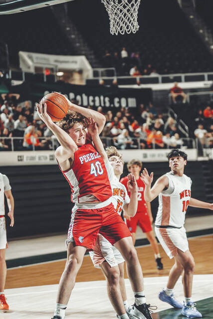 Peebles freshman Keegan Puckett (40) wrestles down an offensive rebound during the Indians 42-32 loss to Portsmouth West in the Division VI regional semifinals. (Photo by Mandy Lynn Photography)