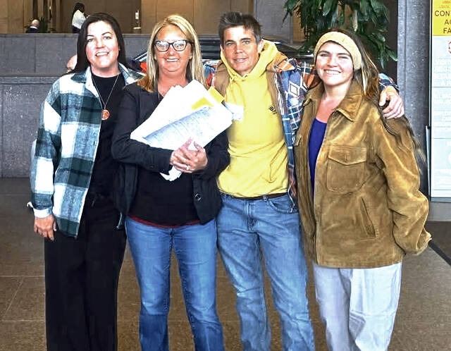 From left, Emily Harper, Jessica Adams Baker, Nikki Gerber, and Danielle Nicole Kinhalt stand together in Columbus on Monday, March 16, 2026, after delivering petitions to the Ohio Attorney Generals Office seeking a constitutional amendment to ban data centers larger than 25 megawatts.(Submitted photo)