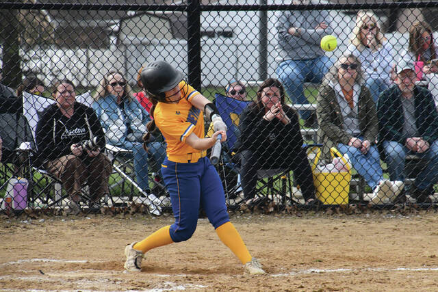 This swing by Manchesters Elliana Applegate resulted in a three-run homer in the third inning of the Lady Hounds season-opening extra inning loss at Georgetown. (Photo by Mark Carpenter)