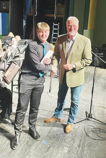 Leeland Barry receives his Maggie Hoff Scholarship from Ken Smith during the annual All-County Arts & Music Festival. (Photo provided)