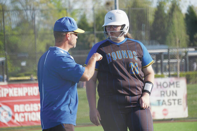 Manchesters Mahayla Brown confers with third base coach Matthias Applegate during the Lady Hounds trip to Tennessee last weekend. (Photo by Chasity Boden Hayslip)
