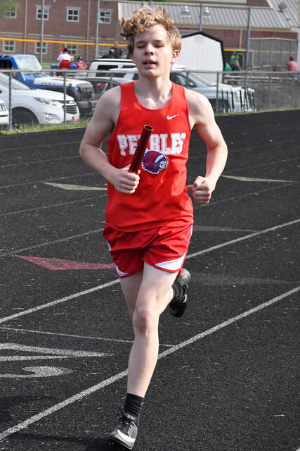 Peebles freshman Ashton Ashworth runs his leg in the Boys 4 x800 Relay in action from the April 14 West Union Invitational. (Photo by Mark Carpenter)
