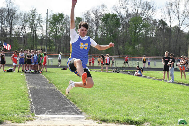 Manchesters Korey Gray flies through the air competing in the Boys Long Jump at the recent West Union Invitational Meet. (Photo by Mark Carpenter)