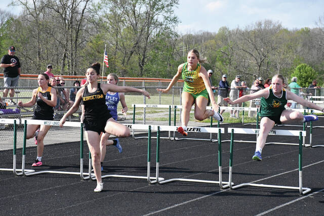 North Adams Morgan Wheeler, far right, and West Unions Jocelyn Hall compete on the Girls 100m Hurdles at last weeks West Union Invitational. (Photo by Mark Carpenter)