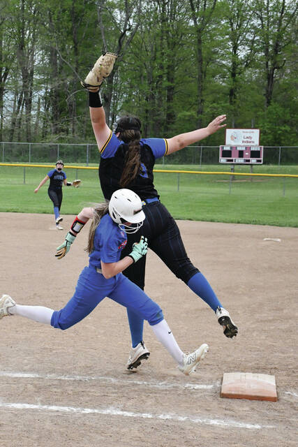 Manchester first baseman Mahayla Brown goes airborne to haul in a throw in action from the Lady Hounds 3-2 loss to Peebles on April 18. (Photo by Mark Carpenter)