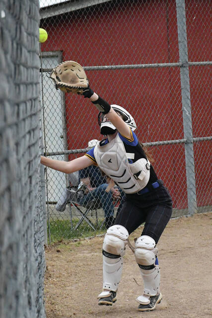 Manchester catcher Brislynn McClanahan chases down a foul pop-up during the Lady Hounds 3-2 loss at Peebles last weekend. (Photo by Mark Carpenter)