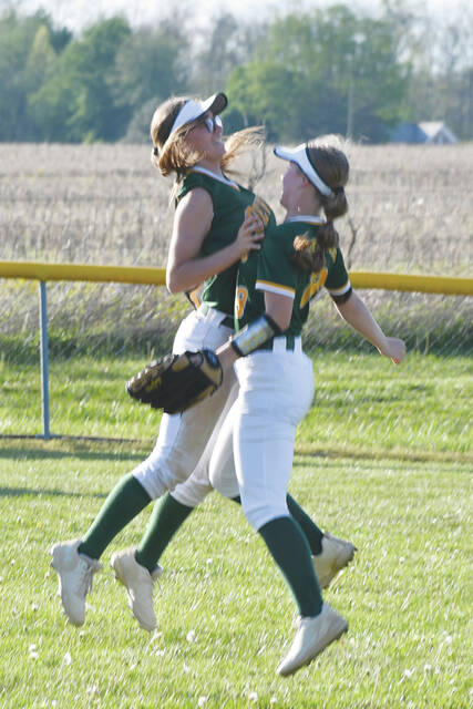 North Adams center fielder Lilly Parker, left, and right fielder Melanie Wood celebrate after a catch in the Lady Devils 8-3 win over Eastern Brown on April 16. (Photo by Mark Carpenter)