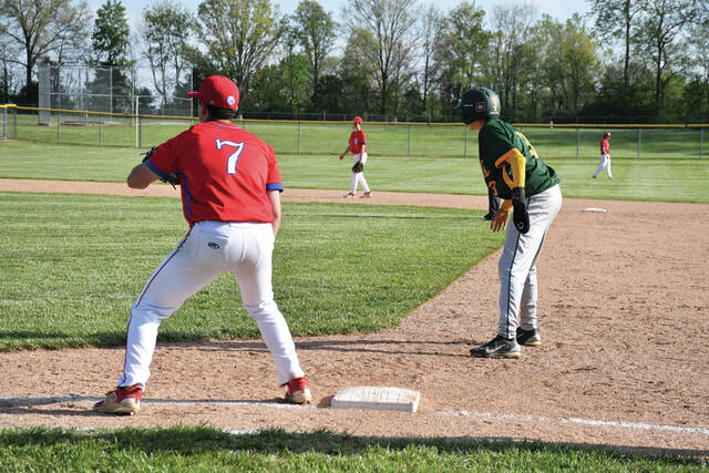 Peebles first baseman Nash Grooms (7) holds on North Adams base runner Maverick Winkler in action from last weeks SHAC match up . (Photo by Mark Carpenter)