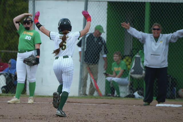 North Adams Carlee Garrison (6) and head coach Paula Armstrong celebrate after Garrisons second inning home run in the Lady Devils conference clinching 12-0 win at West Union on April 29. (Photo by Tim Daulton)