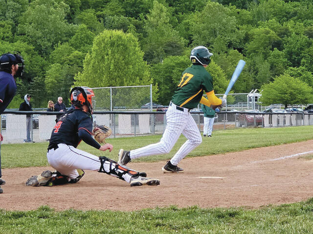 North Adams sophomore Jaxon Krchmar follows through with a swing as the Green Devils battled Portsmouth West in the annual Wood bat Classic. (Photo by Michael Krchmar)