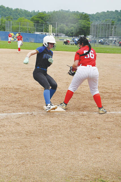 Manchesters Addilyn Hunter steps safely into third base before the tag of Peebles third baseman Riley Byers during the SHAC match up on May 5. (Photo by Mark Carpenter)