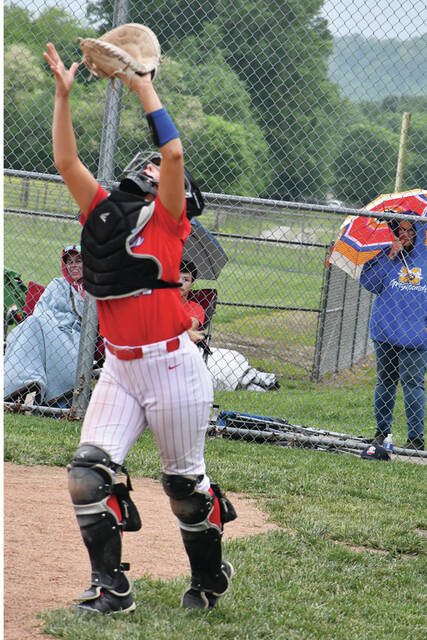 Peebles sophomore catcher Kendall Myers settles under a foul pop up in action from the Indians 7-4 win at Manchester on May 5. At the plate, Myers blasted a sixth inning homer that gave her team the lead for good. (Photo by Mark Carpenter)