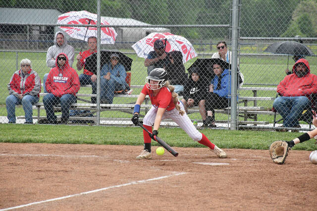 Peebles Kendall Young places down a bunt in one of her plate appearances in the Lady Indians 7-4 win at Manchester on May 5. (Photo by Mark Carpenter)