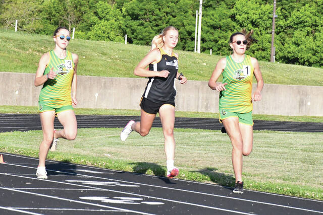 West Unions Stella Rhonemus, left, and Ella Shupert, right, vie for position in the Girls 1600M run at last week Southern Hills Athletic Conference Track Meet. (Photo by Mark Carpenter)