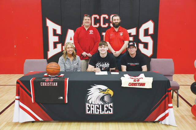 Adams County Christian senior Jed Shivener signed his Letter of Intent to continue his career at Kentucky Christian University. Front row, from left, Kellie Shivener (mother), Jed Shivener and Kenny Shivener (father); Back row, from left, Charlie Pack (KCU Mens Head Coach) and Dan Wilson (ACCS Boys Coach). (Photo by Mark Carpenter)