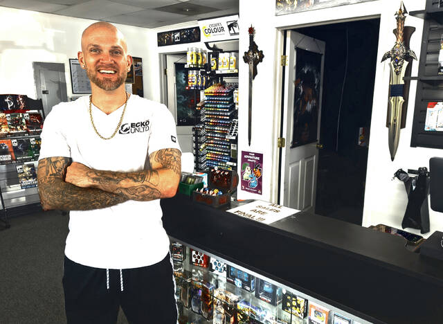 Time Trap Gaming owner Ian Strathie stands inside the shops new location at 509 East Main Street in West Union. The expanded space allows the business to host larger organized play events for games including Magic: The Gathering, Pokemon and Warhammer while also supporting additional tabletop gaming opportunities. (Photo by Ryan Applegate)
