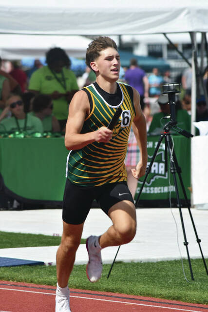 In his final race as a Green Devil North Adams senior Dalton Pence carries the baton in the 4 x 400 relay at the OHSA A State Track Meet. (Photo by Danielle Jodrey)