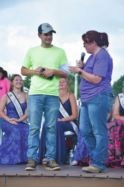 Adams County 4-H Educator Kristy Watters, right, presents the 4-H Alumni Award to Ryan Shoemaker. (Photo by Mark Carpenter)
