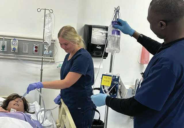 Southern State students Ciara Wood (left) of Fayetteville and James Ahigeneye (right) of Batavia build confidence and clinical skills through hands-on simulation, preparing to deliver safe, compassionate patient care.