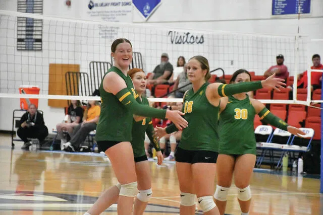 The North Adams Lady Devils celebrate a point in the first set of their preview match up with the Fairfield Lady Lions. (Photo by Mark Carpenter)
