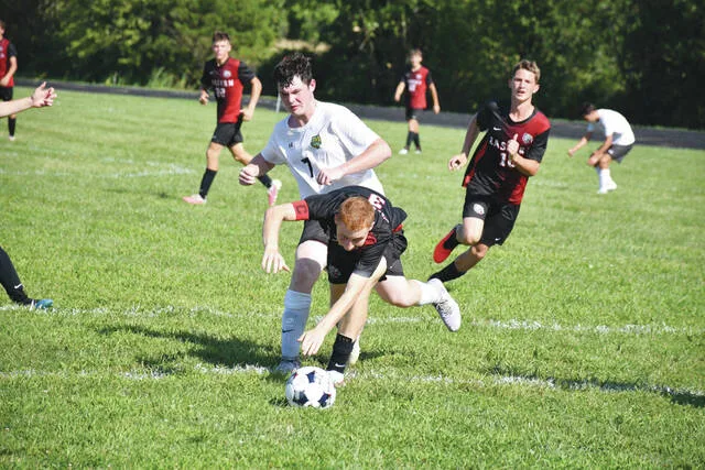 West Union freshman Keith Sowards (7) battles for possession with an Eastern opponent in the first half as the two teams battled to a 1-1 tie in an August 14 conference tilt at Eastern Brown. (Photo by Mark Carpenter)