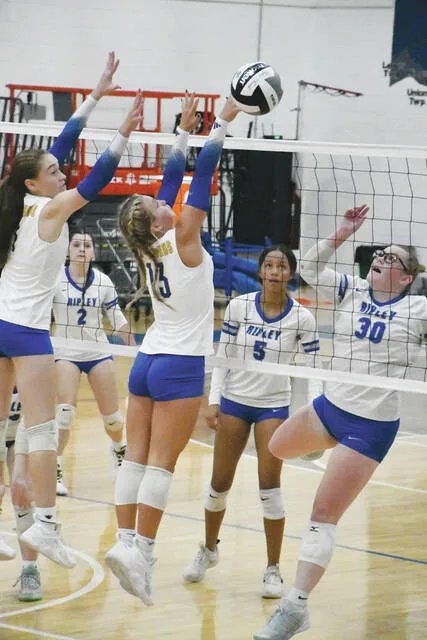 Manchesters Bristynn McClanahan and Maddie Easter go over the net for the block attempt in the Lady Hounds five-set victory over Ripley on September 3. (Photo by Mark Carpenter)
