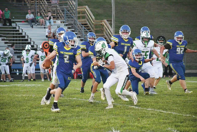 Manchester quarterback Cayden Allen looks to turn the corner on this first half run in the Greyhounds 36-24 win over Green on September 4 at Veterans Stadium. Allen ran for two fourth quarter touchdowns as the Hounds improved to 1-1 on the season. (Photo by Mark Carpenter)