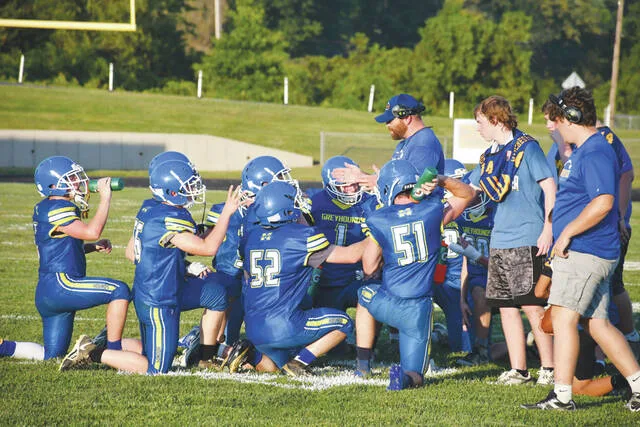 Head Coach Justin Schmitz and his Manchester Greyhounds beat the heat last Friday evening to pick up their first win of 2026, 36-24 over the Green Bobcats. (Photo by Mark Carpenter)