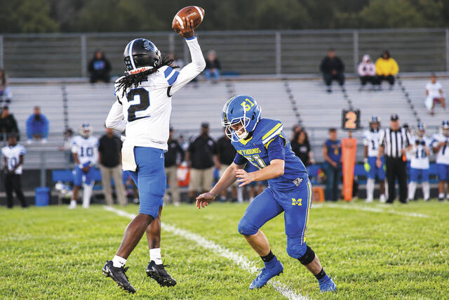 Manchester defensive lineman Remington Hayslip is about to put the hammer down on Clark Montessori quarterback Karter Lipscomb in action from last Saturday nights contest at Veterans Stadium. (Photo by Mark Carpenter)
