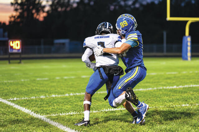 Manchester defender Tyler Vaughn runs down the ball carrier, Clark Montessoris Jayden Davis, in the first half of the Greyhounds 28-12 loss on September 26. (Photo by Mark Carpenter)